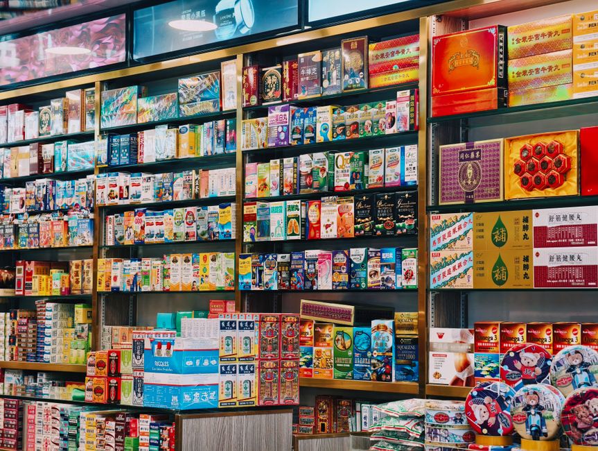 Bright and colorful display of various Asian products on supermarket shelves.