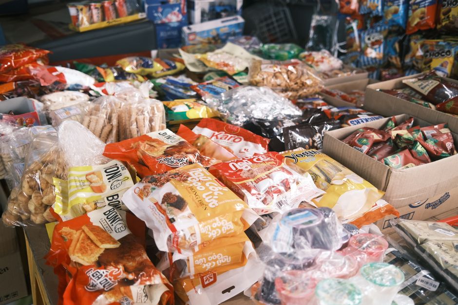 Vibrant array of assorted packaged snacks and candies displayed indoors, perfect for a snack shop or market.